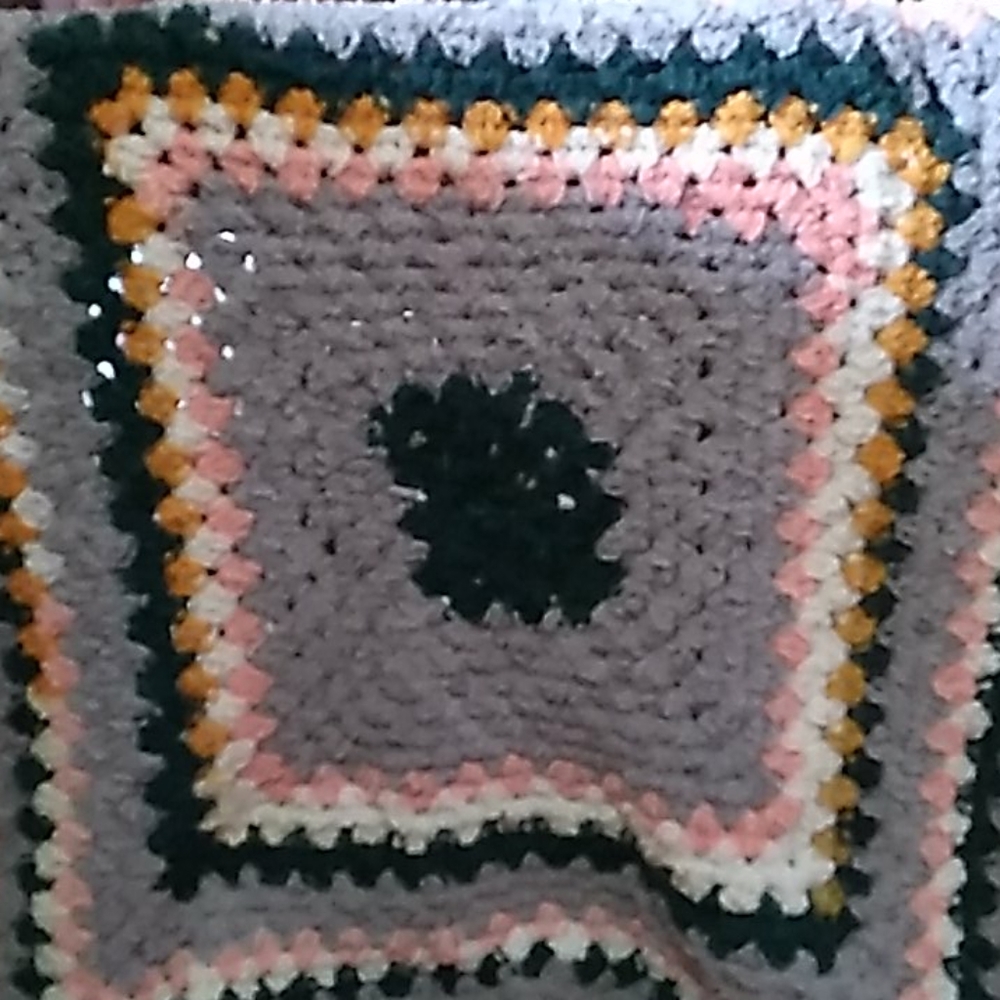 Green, pink, orange, white,and grey baby blanket